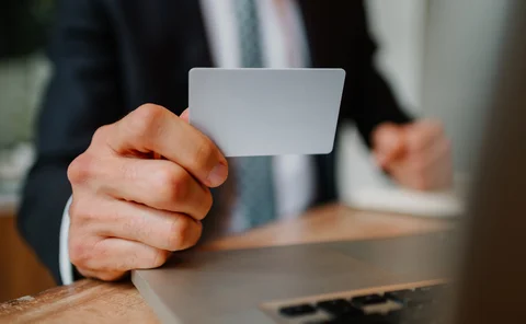 Blurred man holding a blank (plain white) card