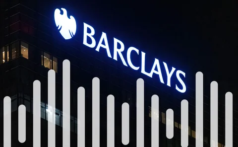 Barclays Bank offices at night with corporate logo shining brightly