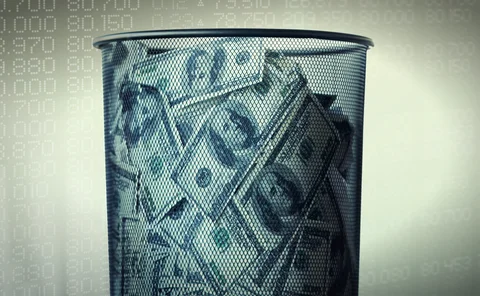 Pile of dollars in a waste paper bin superimposed on a securities ticker background