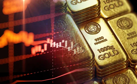 Montage of gold bars against an options trading chart on screen