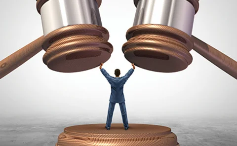 Man being crushed by gavels